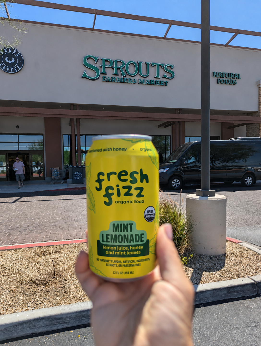 Fresh Fizz Mint Lemonade held outside a Sprouts Farmers Market